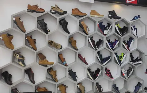Formal and casual shoes arranged on honeycomb shelving