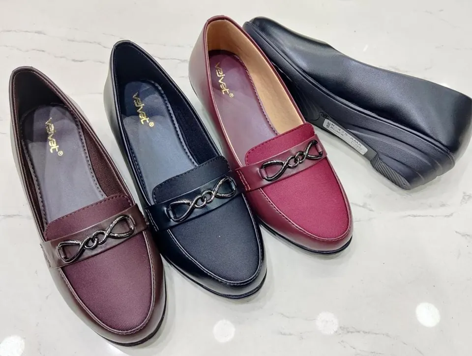 Close-up of ladies' loafers in maroon, navy and grey