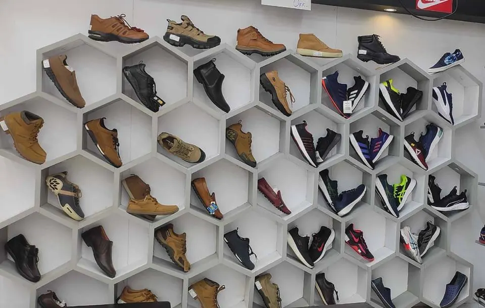 Hexagon shelf display of men's formal and casual shoes in the Waidhan showroom